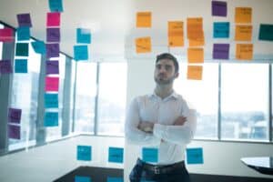 Male executive reading sticky note